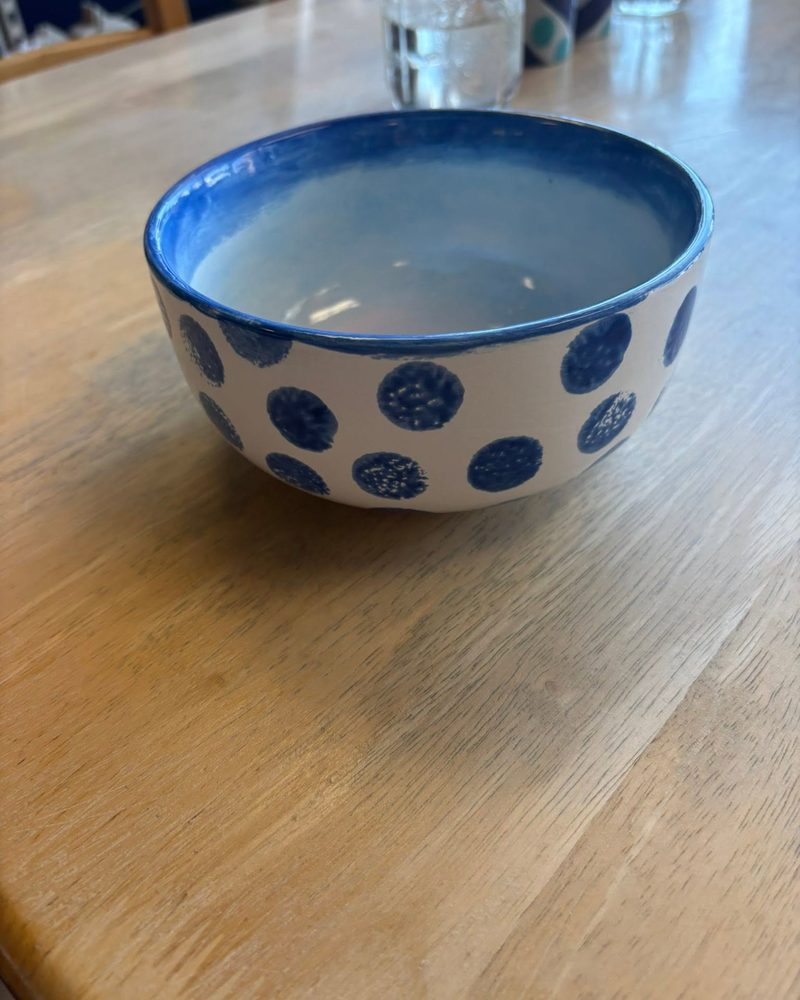 Bowl with a blue rim and large blue polka dots