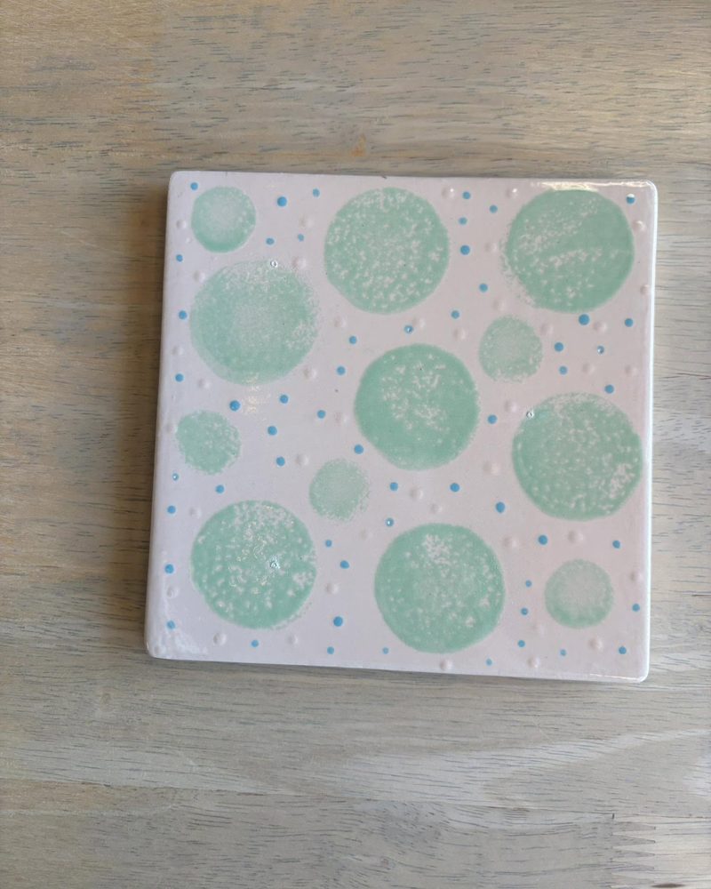 Square tile with mint green bubbles and blue dots