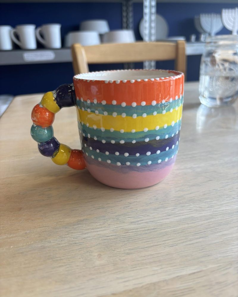 Rainbow striped mug with a beaded handle
