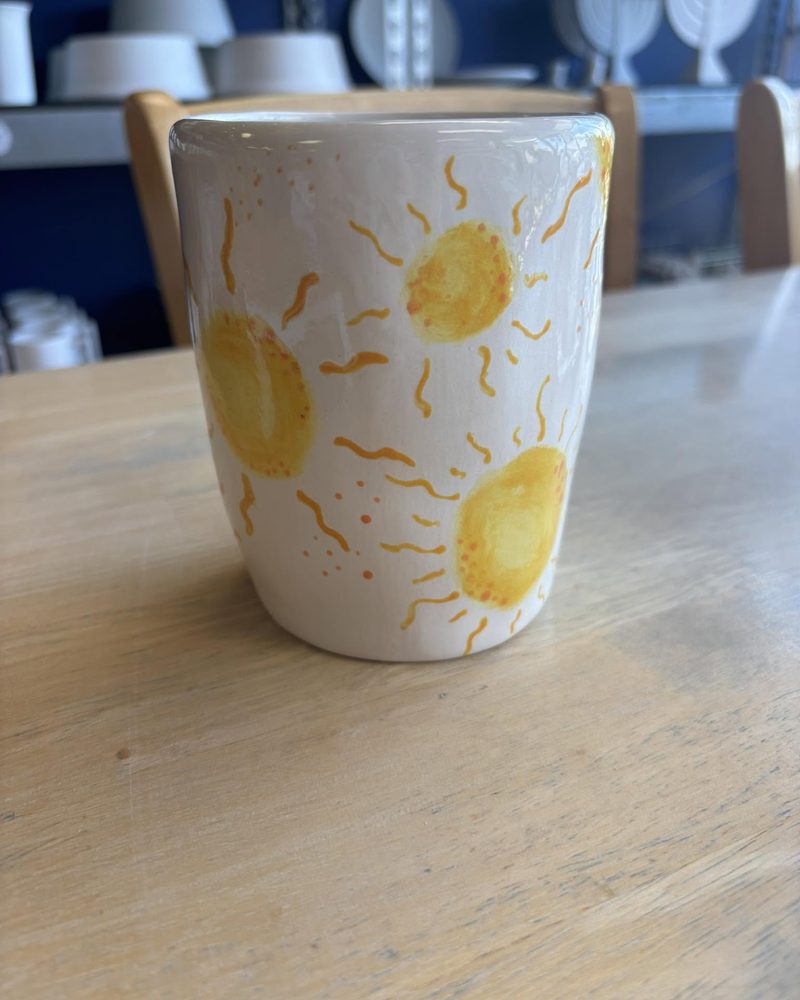 Tall cup painted with yellow suns