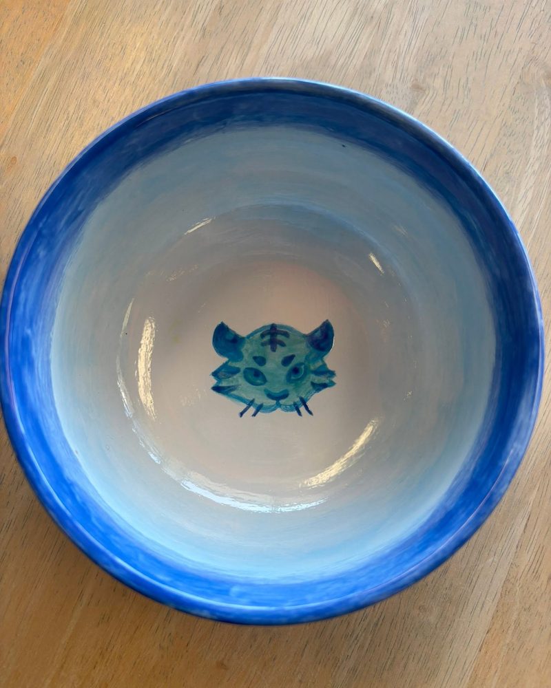 Blue bowl with a painted tiger face